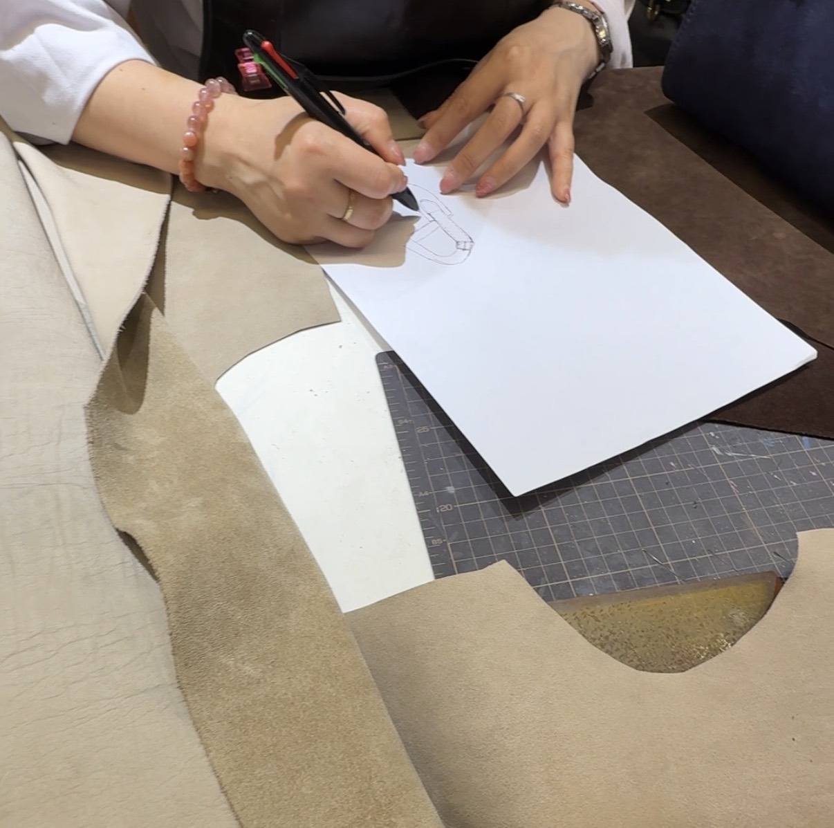 Sketching the bag design on leather
